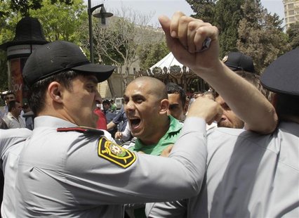 Opposition supporters scuffle with police during an anti-government protest in central Baku May 21, 2012. REUTERS/David Mdzinarishvili Opposition supporters scuffle with police during an anti-government protest in central Baku May 21, 2012. REUTERS/David Mdzinarishvili