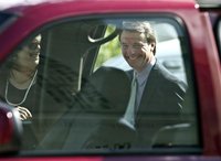 John Edwards laughs with his daughter, Cate Edwards (L), while leaving after the second day of jury deliberations at the federal courthouse 