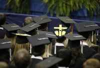 A student wears a mortorboard with a symbol for an aborted fetus, during a commencement address by U.S. President Barack Obama at the Univer