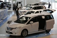 People look at Nissan Motor Co's cars at the company showroom in Yokohama, south of Tokyo May 11, 2012. REUTERS/Toru Hanai