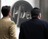 People walk past the Pfizer World headquaters in New York, February 3, 2010. REUTERS/Brendan McDermid