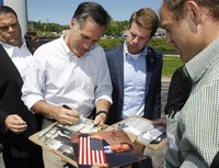 Republican presidential candidate and former Massachusetts Governor Mitt Romney signs autographs for supporters during a campaign event in H