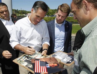 Republican presidential candidate and former Massachusetts Governor Mitt Romney signs autographs for supporters during a campaign event in H Republican presidential candidate and former Massachusetts Governor Mitt Romney signs autographs for supporters during a campaign event in H