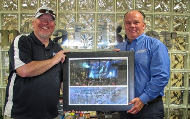 Dave Kallawy presenting Chuck Gahagan of Central Beer with a plaque for their sponsorship of the first 95-5 WIFC's Totally 80's for a Cause.