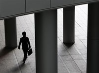 A businessman walks past pillars in Tokyo December 14, 2009. REUTERS/Yuriko Nakao