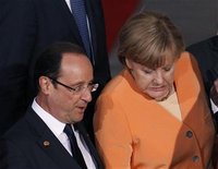 German Chancellor Angela Merkel (C) grimaces as she steps off a stage following a family photo with NATO leaders including French President 