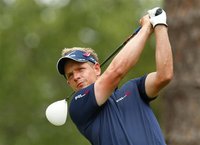 Britian's Luke Donald watches his tee shot on the second hold during the final round of the Players Championship PGA golf tournament at TPC 