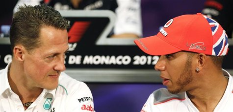 McLaren Formula One driver Lewis Hamilton (R) of Britain talks with Mercedes Formula One driver Michael Schumacher of Germany during a news McLaren Formula One driver Lewis Hamilton (R) of Britain talks with Mercedes Formula One driver Michael Schumacher of Germany during a news