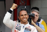McLaren Formula One driver Lewis Hamilton of Britain celebrates after taking the pole position in the qualifying session of the Spanish F1 G