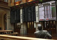 A man looks at information screens at the Madrid stock exchange May 23, 2012. REUTERS/Andrea Comas