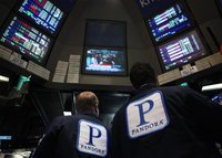 Traders work at the kiosk where Pandora internet radio is traded on the floor of the New York Stock Exchange. REUTERS/Brendan McDermid