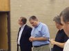 Zeeland Board of Education President Tom DenHerder (C) opens a special meeting on May 24, 2012, into possible disciplinary action against Superintendent Dave Barry.