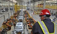 An employee looks at an assembly line at a Ford manufacturing plant in Chongqing municipality April 20, 2012. REUTERS/Stringer