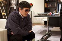 A handout photo from the U.S. Embassy Beijing Press office shows blind activist Chen Guangcheng (C) speaking into a phone in Beijing, May 2,
