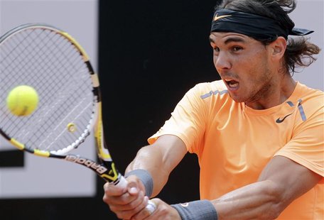 Rafael Nadal of Spain returns the ball to Novak Djokovic of Serbia during their men's singles final match at the Rome Masters tennis tournam Rafael Nadal of Spain returns the ball to Novak Djokovic of Serbia during their men's singles final match at the Rome Masters tennis tournam