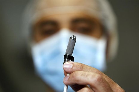 An Italian heart surgeon holds a tiny titanium pump, the world's smallest artificial heart, which was implanted in a baby, at the Bambino Ge An Italian heart surgeon holds a tiny titanium pump, the world's smallest artificial heart, which was implanted in a baby, at the Bambino Ge