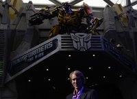 U.S. film director and producer Michael Bay poses below a model of the Bumblebee Autobot character at the premiere launch for the "Transform
