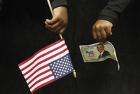 A supporter of U.S. Democratic presidential nominee Senator Barack Obama (D-IL) holds a fake bill with Obama's face at a campaign rally in F