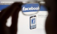 In this photo illustration, a Facebook logo on a computer screen is seen through glasses held by a woman in Bern May 19, 2012. Picture taken