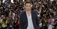 Cast member Robert Pattinson poses during a photocall for the film "Cosmopolis", in competition at the 65th Cannes Film Festival May 25, 201