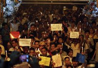 People take a part in a protest against the shortage of electricity, at the Sule Pagoda in central Yangon May 24, 2012. REUTERS/Minzayar