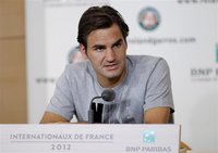 Roger Federer of Switzerland attends a news conference two days before the start of the French Open tennis tournament at the Roland Garros s