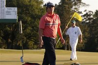 Jason Dufner of the U.S. tosses his putter after sinking a bogey putt on the 18th green during third round play in the 2012 Masters Golf Tou