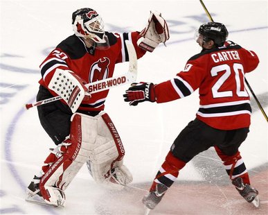 New Jersey Devils goalie Martin Brodeur (L) celebrates with teammate Ryan Carter after the Devils defeated the New York Rangers in Game 6 of New Jersey Devils goalie Martin Brodeur (L) celebrates with teammate Ryan Carter after the Devils defeated the New York Rangers in Game 6 of