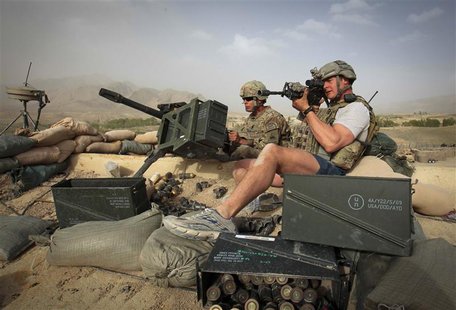 Soldiers from the U.S. Army's 1st Battalion, 41st Infantry Regiment, Task Force Bulldog look at a Taliban position after they attacked the C Soldiers from the U.S. Army's 1st Battalion, 41st Infantry Regiment, Task Force Bulldog look at a Taliban position after they attacked the C