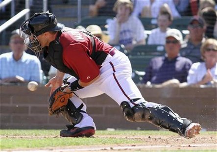 Arizona Diamondbacks' catcher Miguel Montero stops a errant throw during their MLB spring training baseball game against the Chicago White S Arizona Diamondbacks' catcher Miguel Montero stops a errant throw during their MLB spring training baseball game against the Chicago White S