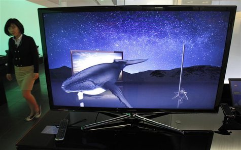 An employee of Samsung Electronics walks past one of its 3D LED televisions displayed for visitors at the company's headquarters in Seoul Ap An employee of Samsung Electronics walks past one of its 3D LED televisions displayed for visitors at the company's headquarters in Seoul Ap