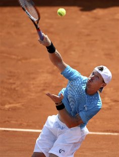 Alex Bogomolov Jr. of Russia serves to Arnaud Clement of France during the French Open tennis tournament at the Roland Garros stadium in Par Alex Bogomolov Jr. of Russia serves to Arnaud Clement of France during the French Open tennis tournament at the Roland Garros stadium in Par