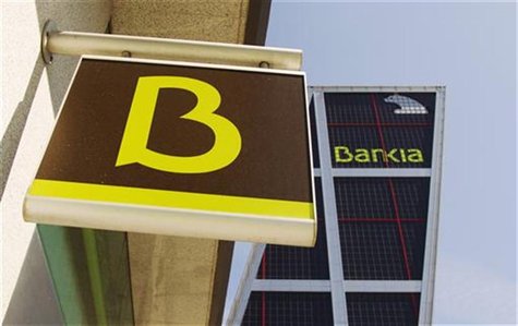The logo of Spain's Bankia bank is seen at one of its branches in front of its headquarters building in Madrid May 28, 2012. Spanish debt yi The logo of Spain's Bankia bank is seen at one of its branches in front of its headquarters building in Madrid May 28, 2012. Spanish debt yi