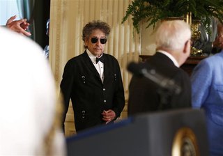 Musician Bob Dylan (C) arrives prior to receiving a Presidential Medal of Freedom in the East Room of the White House in Washington, May 29,