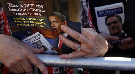 An audience member holds a leaflet, which includes a photograph of President Barack Obama from "Restore Our Future", while attending an even An audience member holds a leaflet, which includes a photograph of President Barack Obama from "Restore Our Future", while attending an even