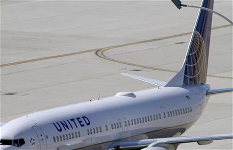 A United Airlines plane with the Continental Airlines logo on its tail, sits at a gate at O'Hare International airport in Chicago October 1, A United Airlines plane with the Continental Airlines logo on its tail, sits at a gate at O'Hare International airport in Chicago October 1,