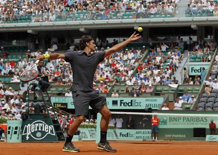 Roger Federer of Switzerland serves to Adrian Ungur of Romania during the French Open tennis tournament at the Roland Garros stadium in Pari Roger Federer of Switzerland serves to Adrian Ungur of Romania during the French Open tennis tournament at the Roland Garros stadium in Pari