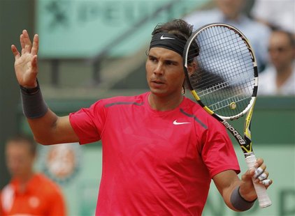 Rafael Nadal of Spain reacts during his match against Denis Istomin of Uzbekistan during the French Open tennis tournament at the Roland Gar Rafael Nadal of Spain reacts during his match against Denis Istomin of Uzbekistan during the French Open tennis tournament at the Roland Gar
