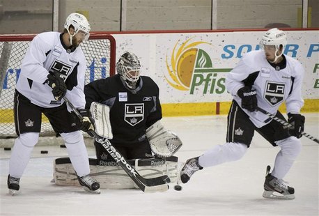 Los Angeles Kings goalie Jonathan Bernier makes a save between left wing Simon Gagne (L) and center Andrei Loktionov (R) as they participate Los Angeles Kings goalie Jonathan Bernier makes a save between left wing Simon Gagne (L) and center Andrei Loktionov (R) as they participate