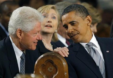 U.S. President Barack Obama (R) talks with former U.S. President Bill Clinton (L) and his wife, Secretary of State, Hillary Clinton (C) duri U.S. President Barack Obama (R) talks with former U.S. President Bill Clinton (L) and his wife, Secretary of State, Hillary Clinton (C) duri