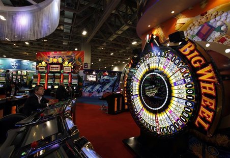A visitor sits in front of a gaming machine at Gaming Expo Asia in Macau May 22, 2012. REUTERS/Bobby Yip A visitor sits in front of a gaming machine at Gaming Expo Asia in Macau May 22, 2012. REUTERS/Bobby Yip