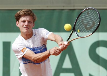 David Goffin of Belgium returns the ball to Lukasz Kubot of Poland during the French Open tennis tournament at the Roland Garros stadium in David Goffin of Belgium returns the ball to Lukasz Kubot of Poland during the French Open tennis tournament at the Roland Garros stadium in
