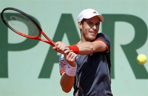 Andy Murray of Britain returns the ball to Santiago Giraldo of Colombia during the French Open tennis tournament at the Roland Garros stadiu Andy Murray of Britain returns the ball to Santiago Giraldo of Colombia during the French Open tennis tournament at the Roland Garros stadiu