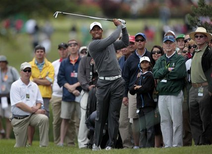 Tiger Woods of the U.S. hits a second shot out of the crowd on the 10th hole during the third round of the Memorial Tournament at Muirfield Tiger Woods of the U.S. hits a second shot out of the crowd on the 10th hole during the third round of the Memorial Tournament at Muirfield