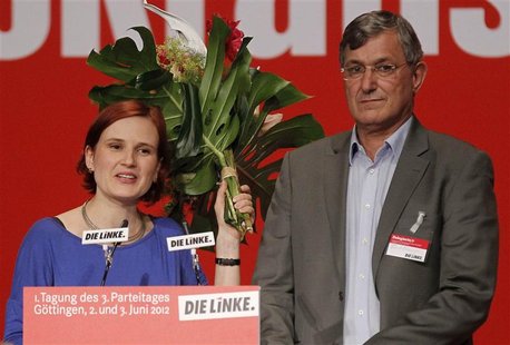 Katja Kipping (L) and Bernd Riexinger, new leaders of Germany's left wing Die Linke party, stand on stage after being elected at a federal p Katja Kipping (L) and Bernd Riexinger, new leaders of Germany's left wing Die Linke party, stand on stage after being elected at a federal p
