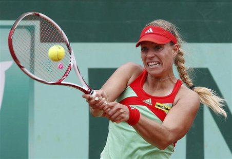 Angelique Kerber of Germany returns the ball to Petra Martic of Croatia during the French Open tennis tournament at the Roland Garros stadiu Angelique Kerber of Germany returns the ball to Petra Martic of Croatia during the French Open tennis tournament at the Roland Garros stadiu