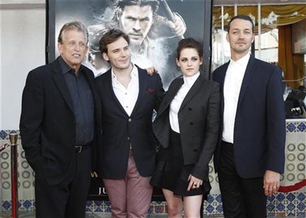 Director of the movie Rupert Sanders (R) poses with cast members Kristen Stewart and Sam Claflin (2nd L), and producer Joe Roth at an indust Director of the movie Rupert Sanders (R) poses with cast members Kristen Stewart and Sam Claflin (2nd L), and producer Joe Roth at an indust