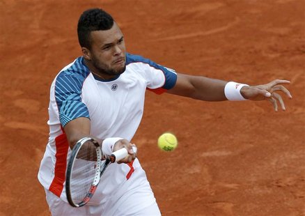 Jo-Wilfried Tsonga of France returns the ball to Stanislas Wawrinka of Switzerland during the French Open tennis tournament at the Roland Ga Jo-Wilfried Tsonga of France returns the ball to Stanislas Wawrinka of Switzerland during the French Open tennis tournament at the Roland Ga