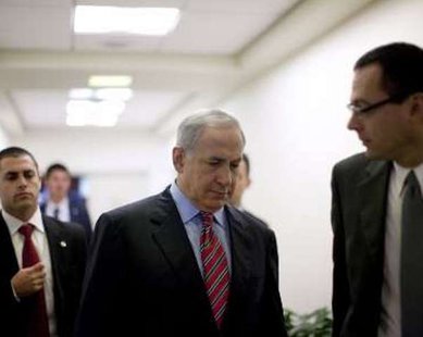 Israel's Prime Minister Benjamin Netanyahu (C) arrives at the weekly cabinet meeting at his office in Jerusalem November 29, 2009. REUTERS/Uriel Sinai/Pool Israel's Prime Minister Benjamin Netanyahu (C) arrives at the weekly cabinet meeting at his office in Jerusalem November 29, 2009. REUTERS/Uriel Sinai/Pool
