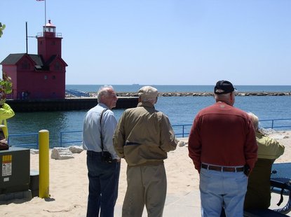 Visitors to Holland State Park watch the SS Keewatin sail on Lake Michigan past Holland Harbor on Monday, June 4. Visitors to Holland State Park watch the SS Keewatin sail on Lake Michigan past Holland Harbor on Monday, June 4.